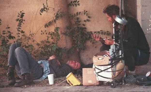  “John Wick” trò chuyện, chia sẻ nước uống với một người vô gia cư. (Nguồn: Mạng xã hội)